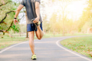 man runner doing stretching exercise