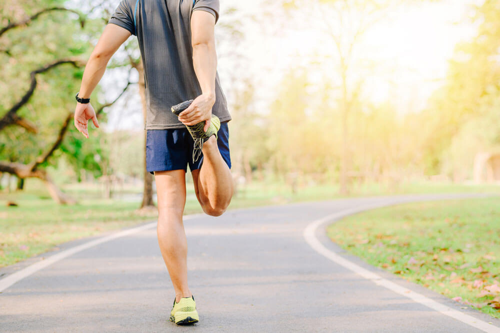 man runner doing stretching exercise