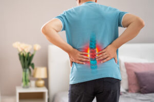 man with back pain at home